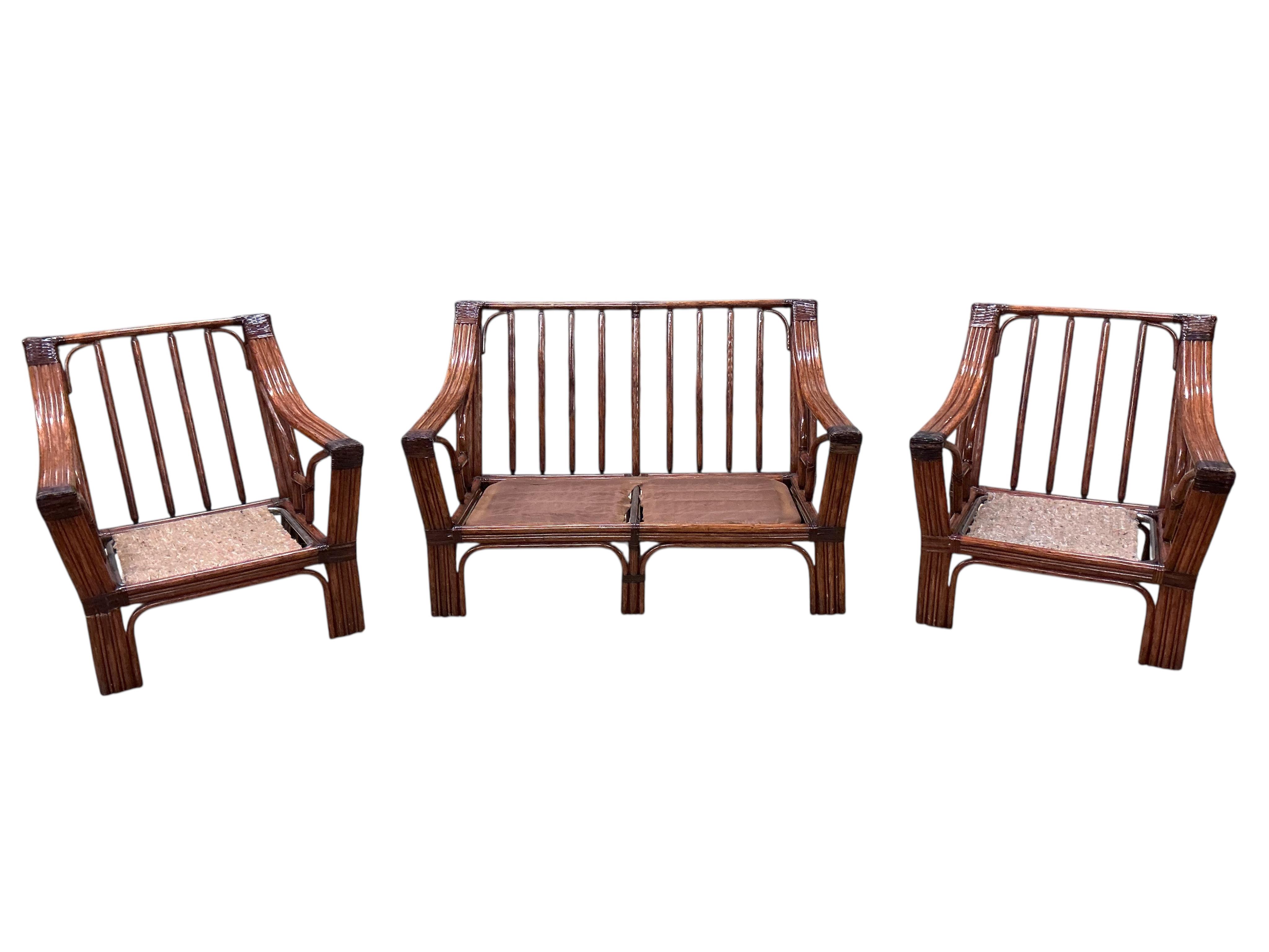 A mid century Roche Bobois faux bamboo three piece suite, lacking some cushions
